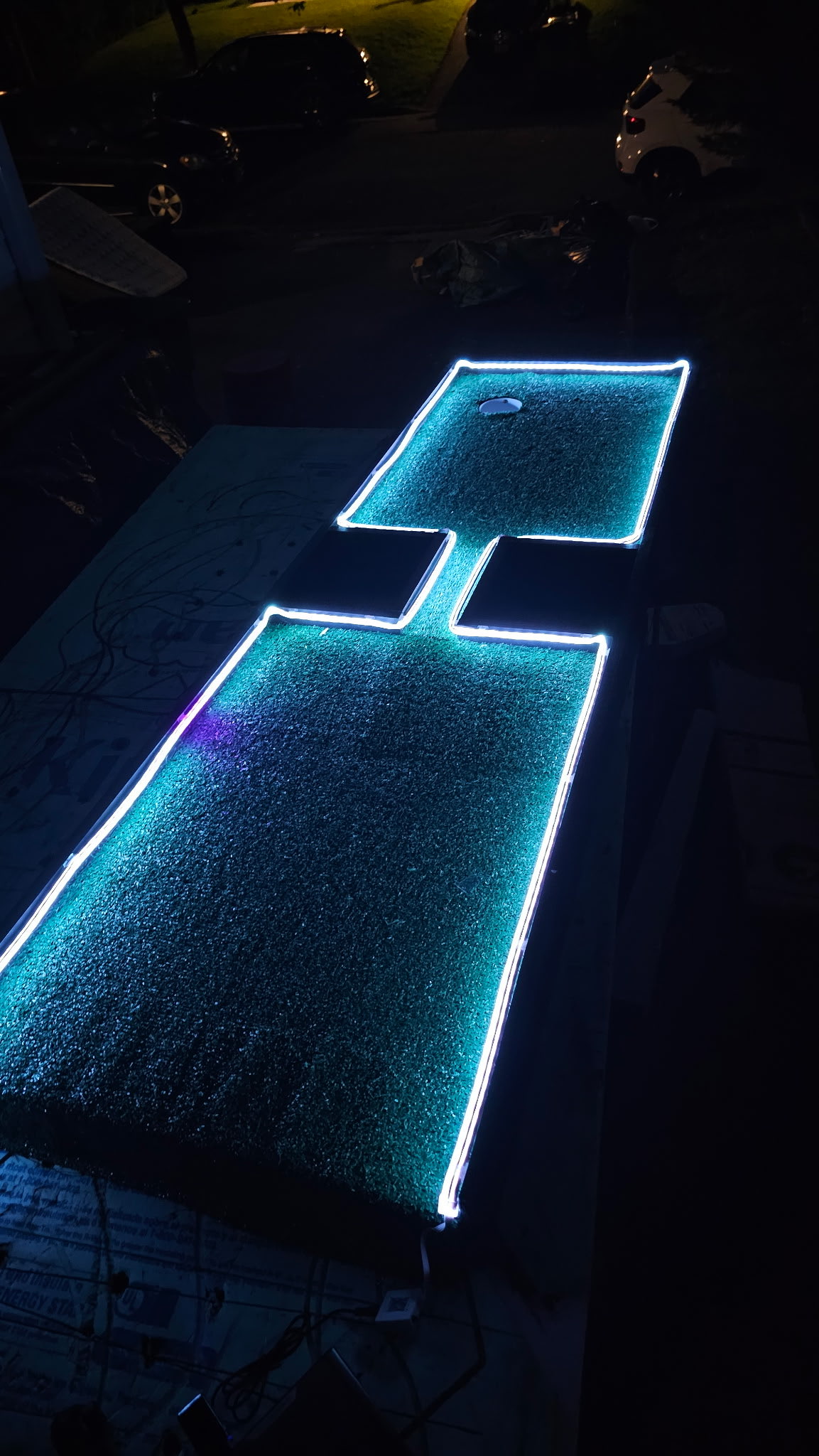The hand-built course glowing with LED edge lighting at night